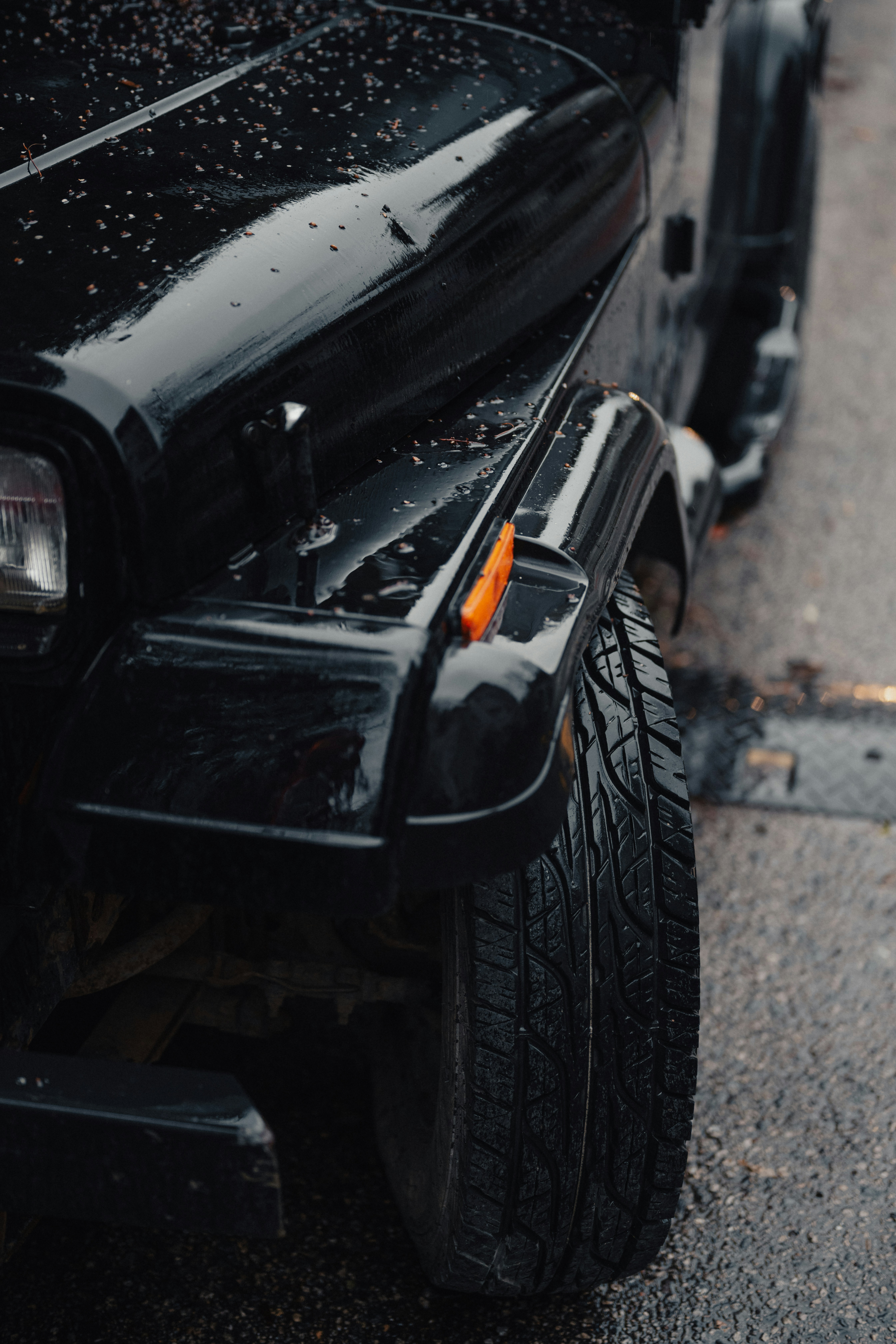 A close up of a black jeep parked on the side of a road