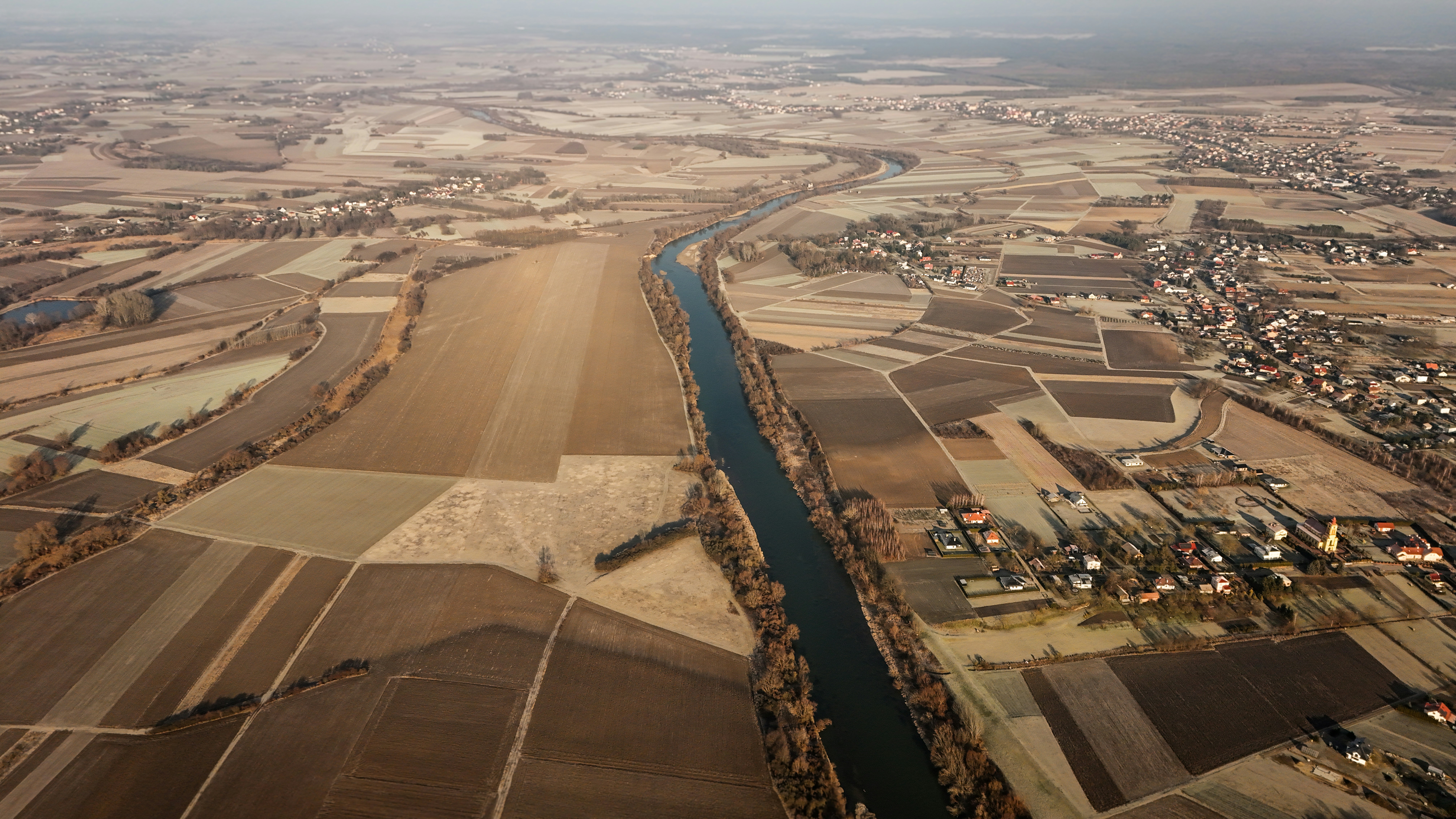 Luftaufnahme eines Flusses, der durch ein Feld fließt