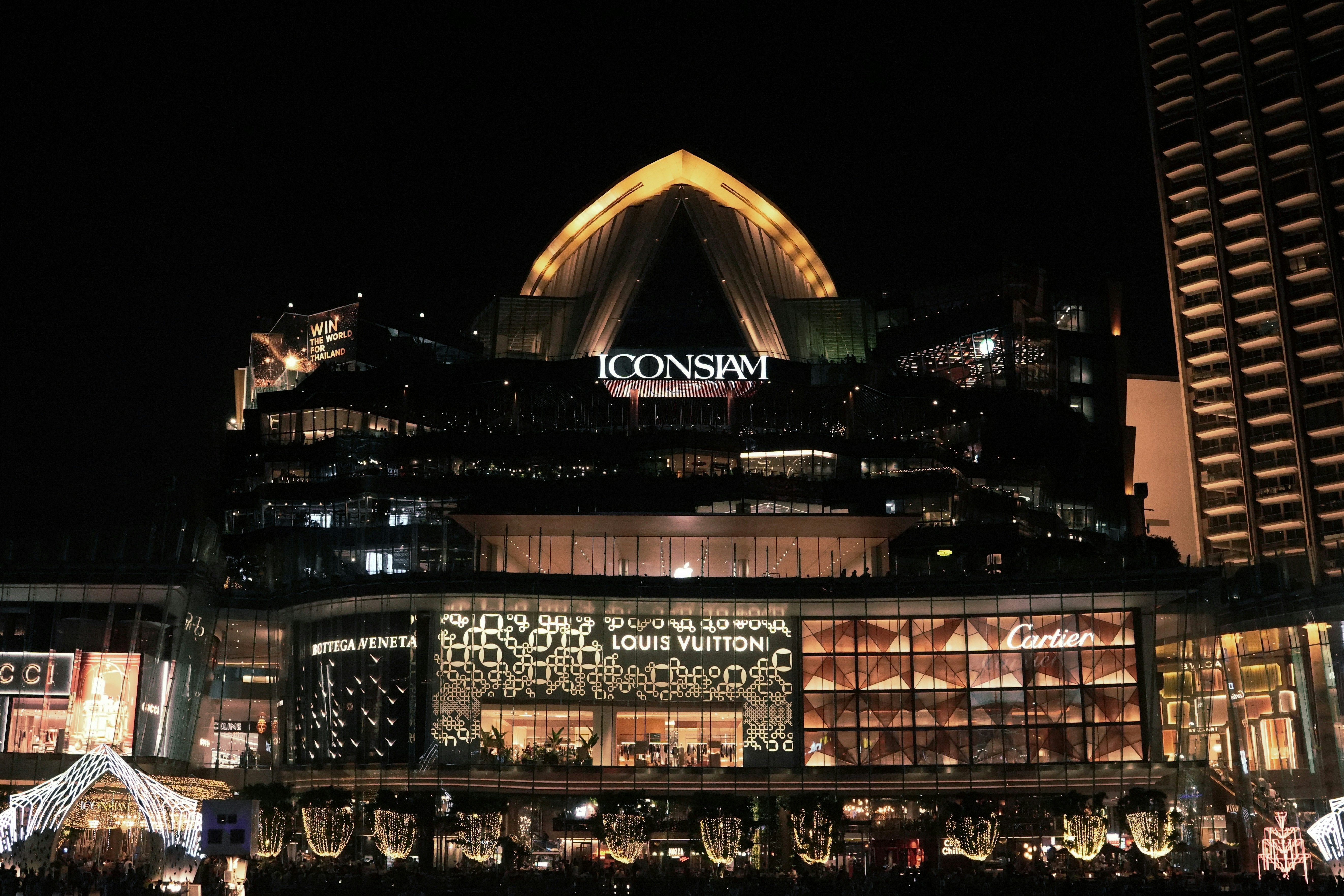 A large building lit up at night in a city