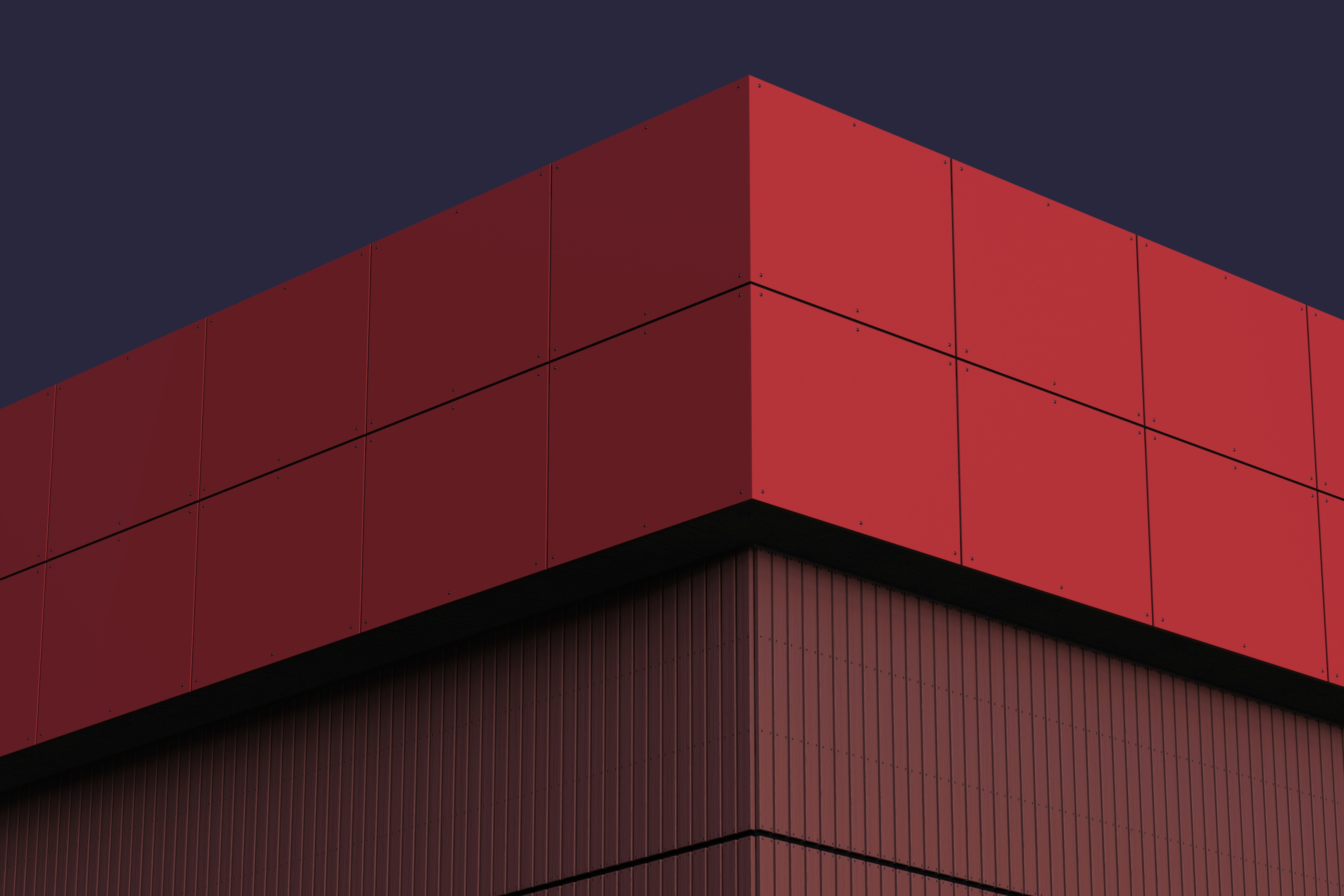 A tall red building with a sky background