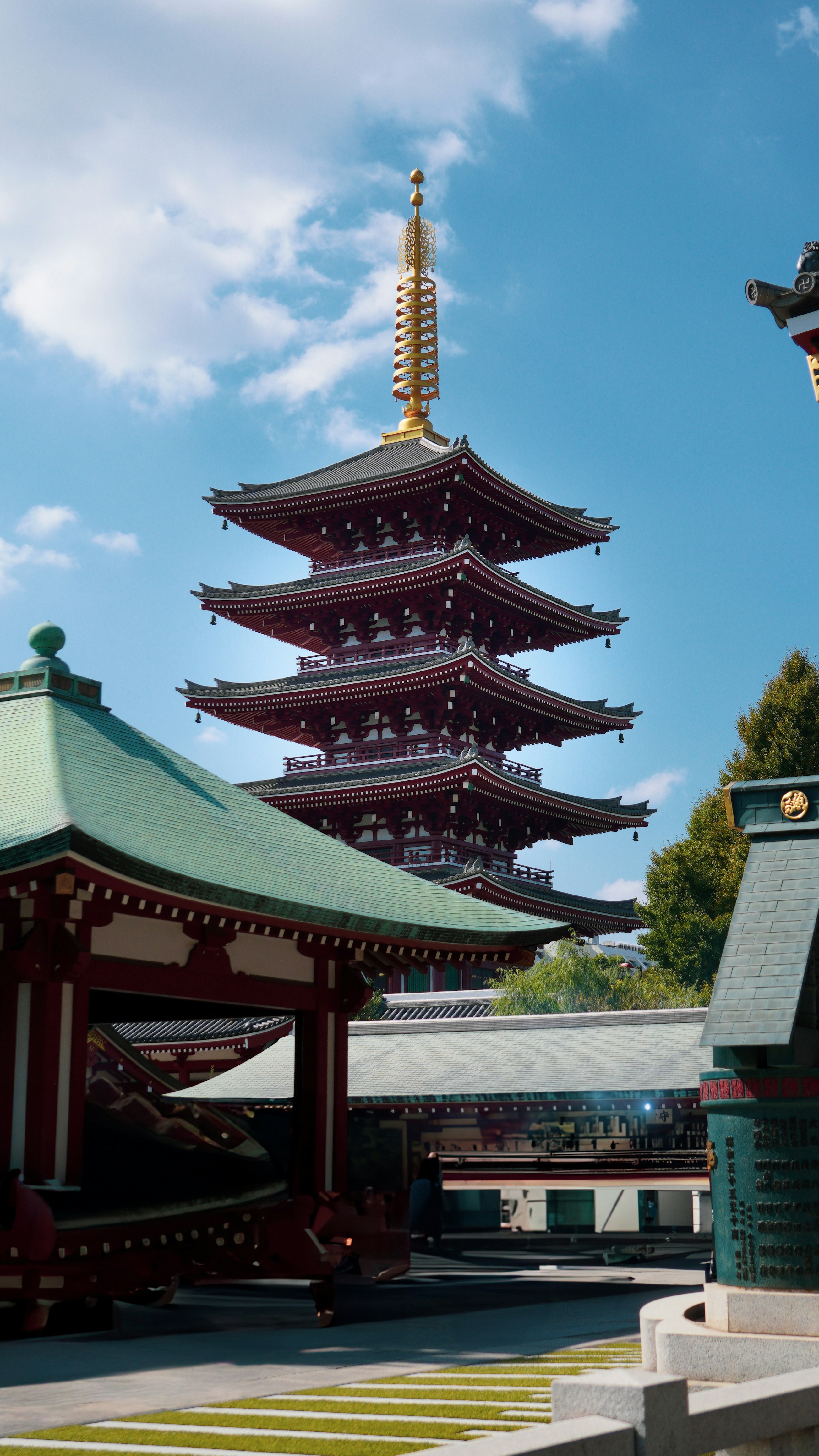 A tall pagoda sitting next to a tall building