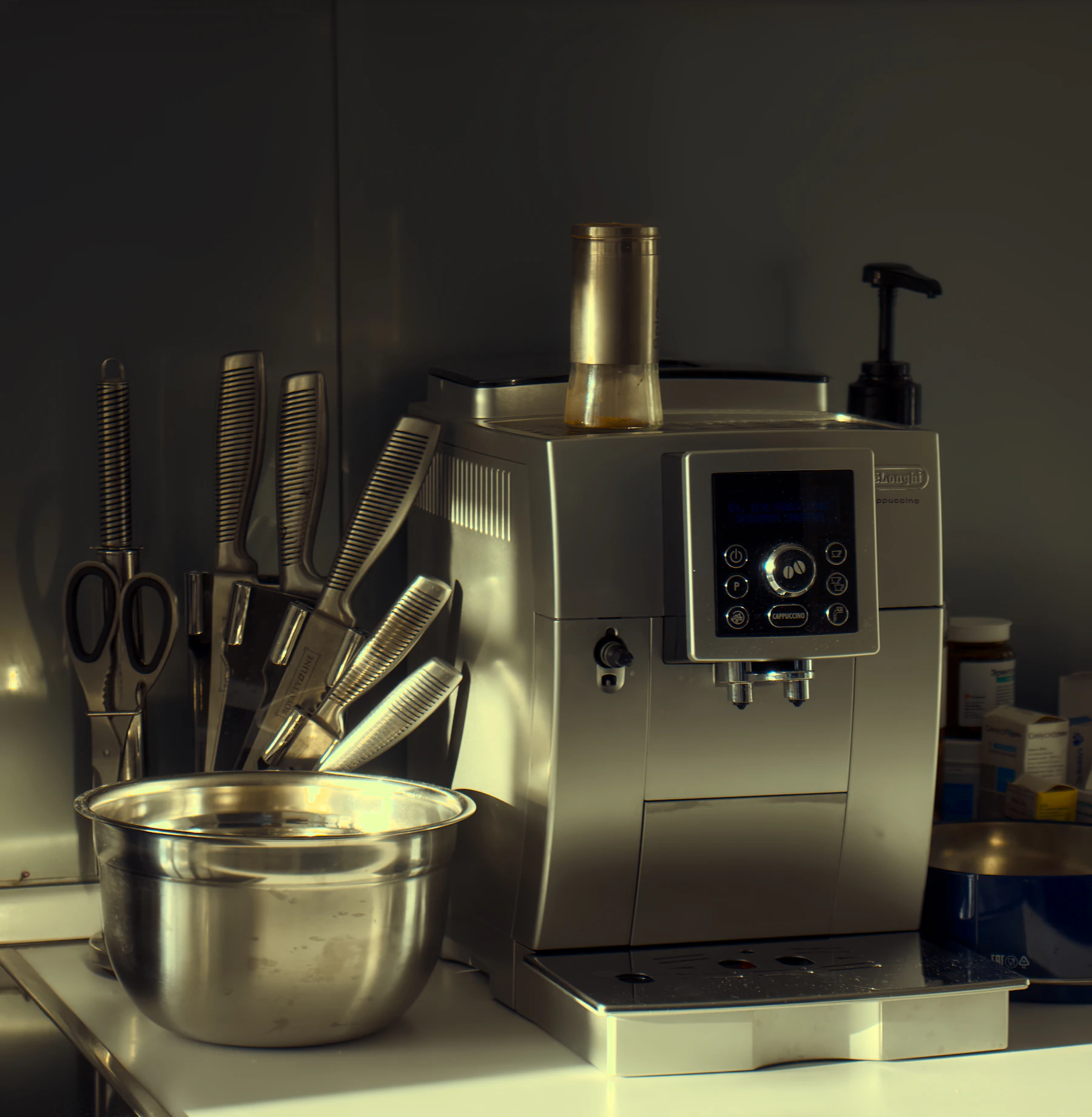 Kitchen counter arranged with countertop appliance, bowl, utensils, and food preparation tools
