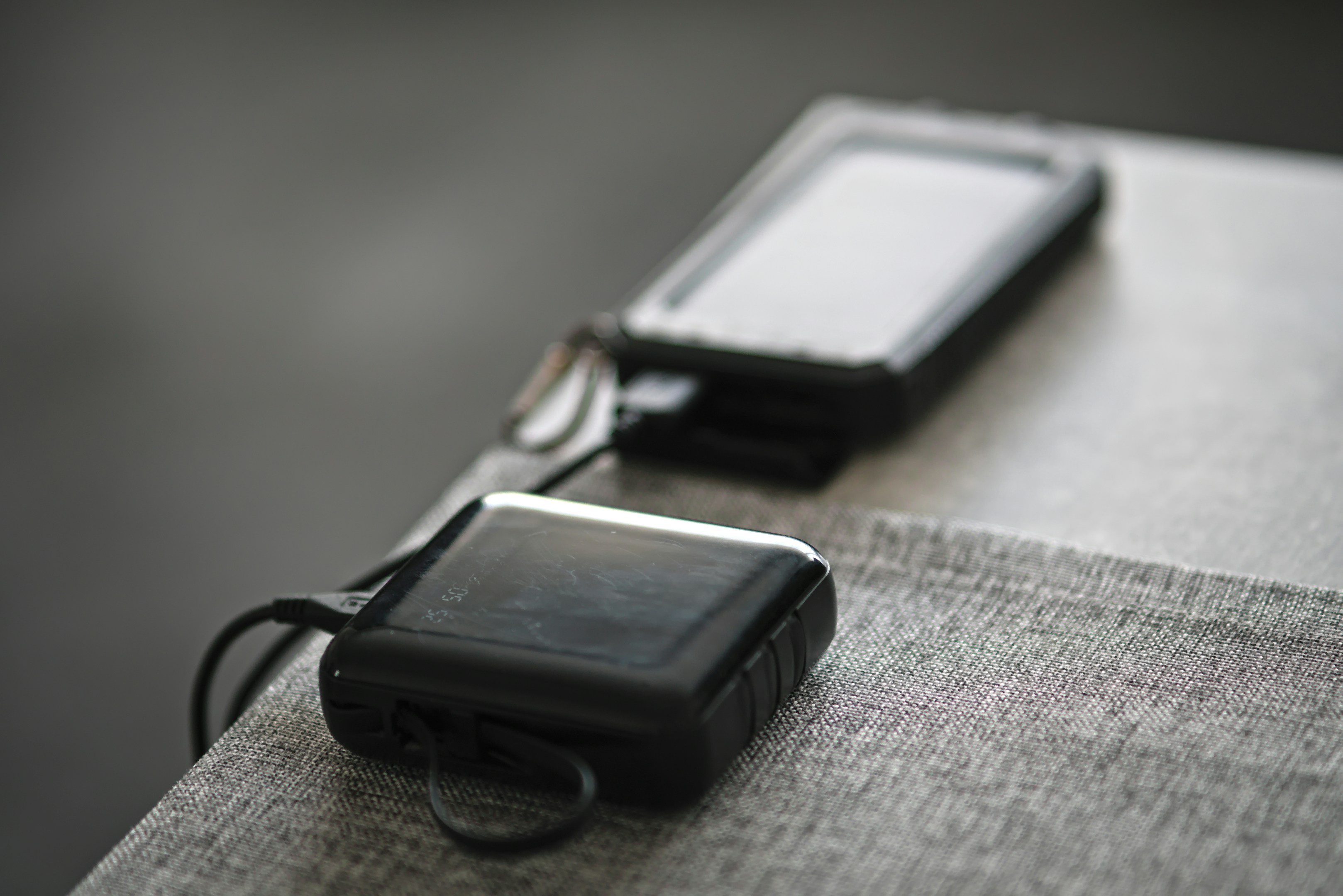 A couple of cell phones sitting on top of a table