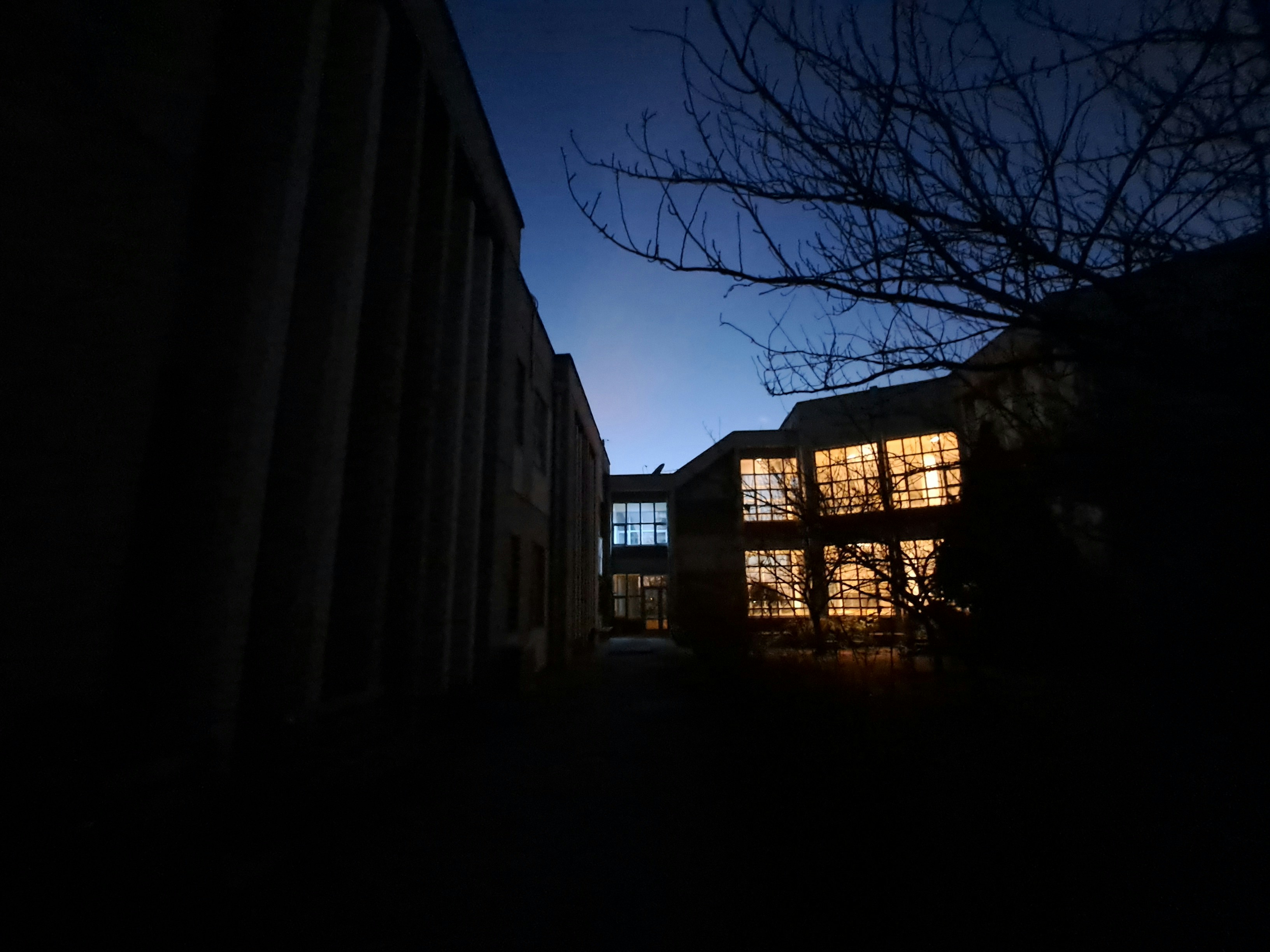 A building with a lot of windows lit up at night