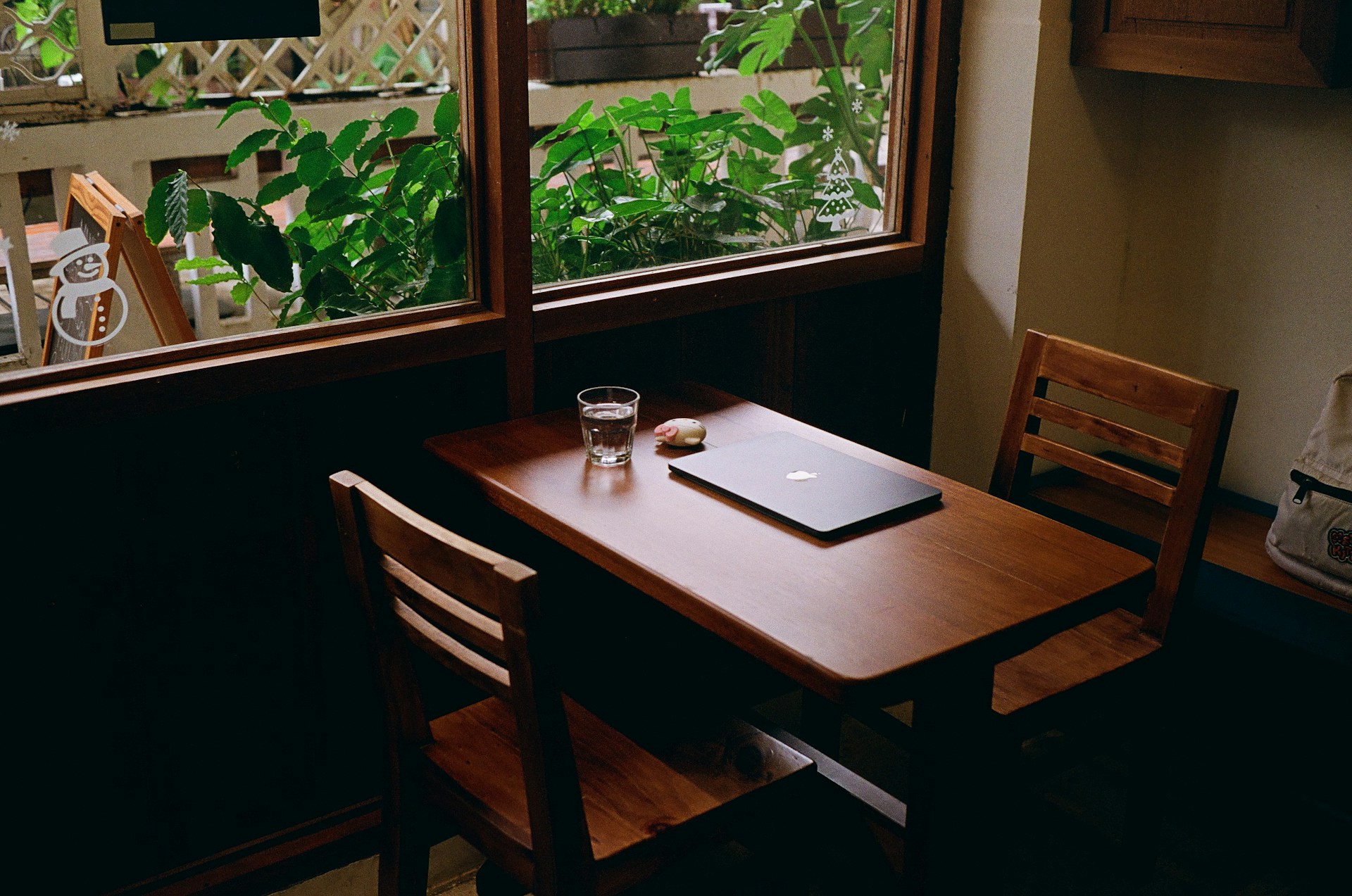 A wooden table with a laptop on top of it