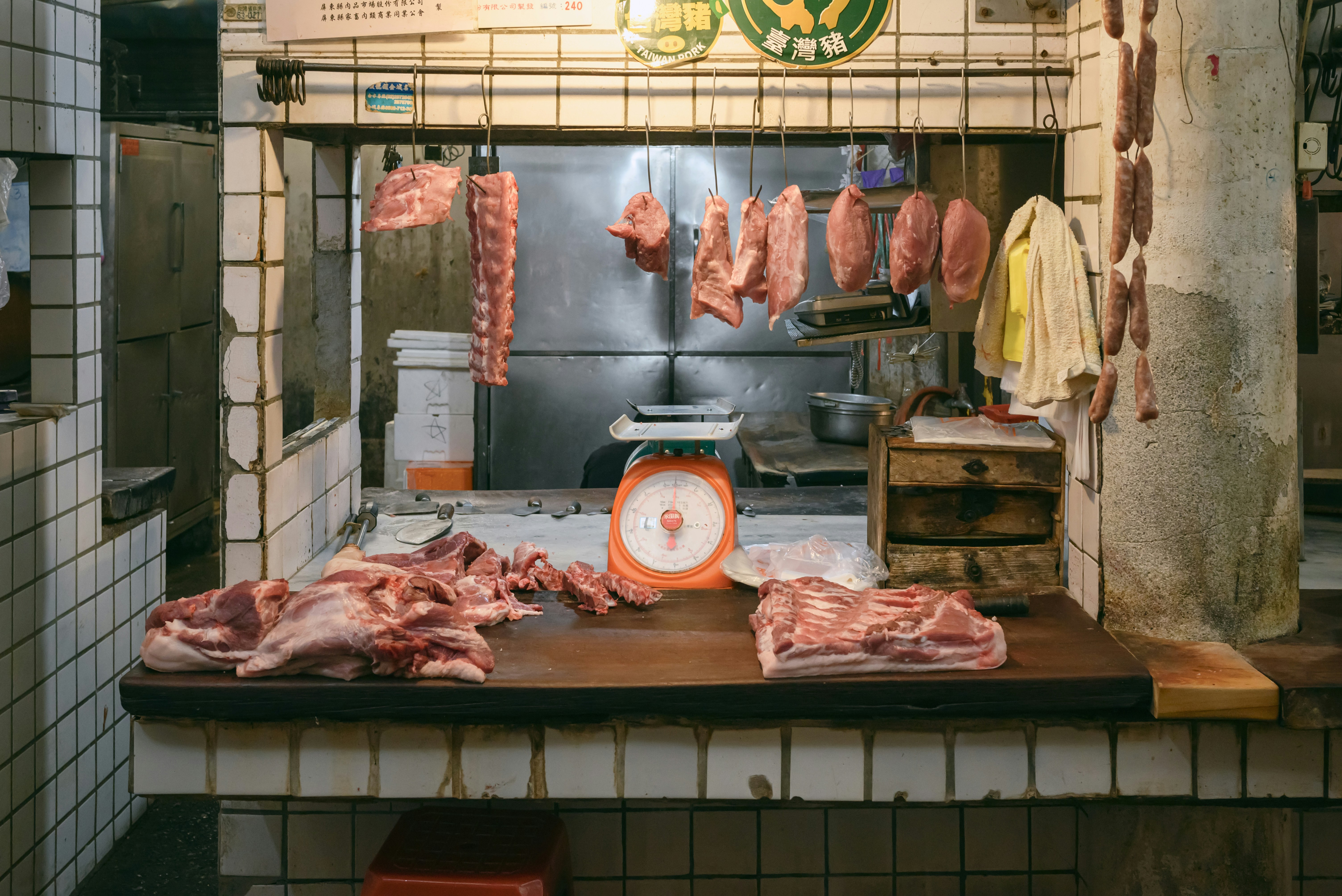 A butcher shop with meat hanging from the ceiling