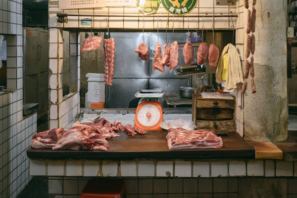Inside Trenchard & Sons: sides of beef hanging in the ageing room