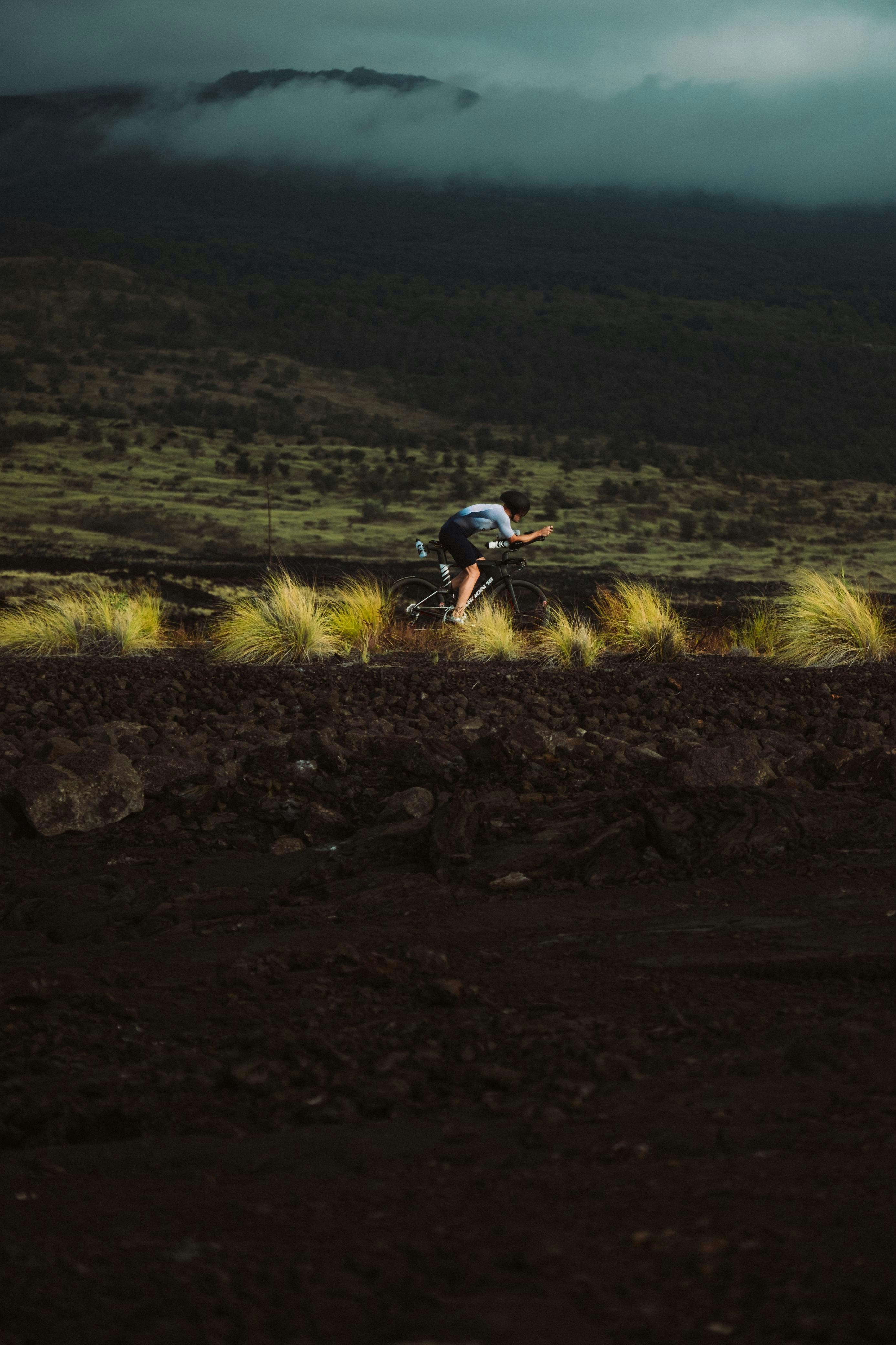 A man riding a bike down a dirt road