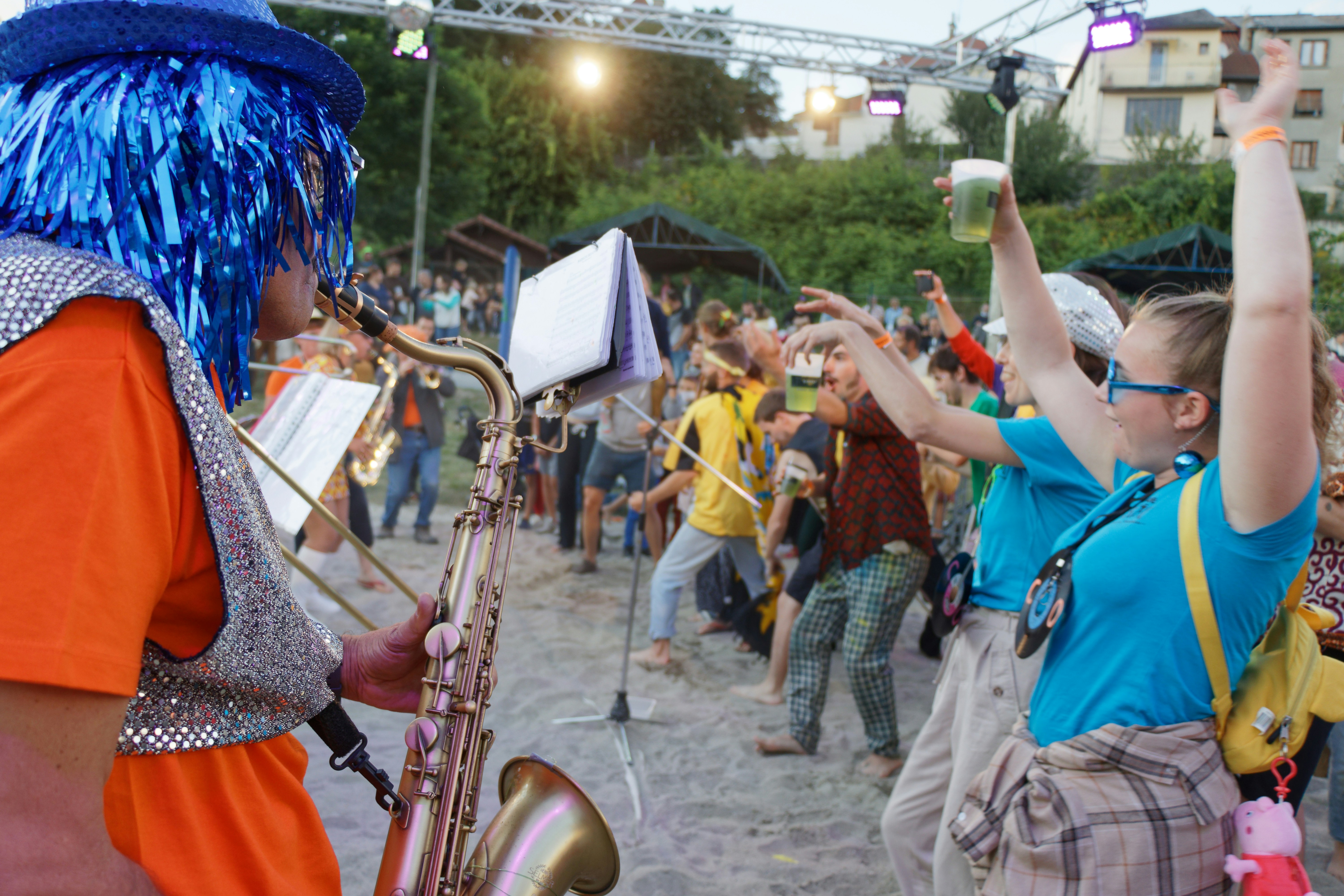 Happy festival-goers dancing and enjoying live music outdoors