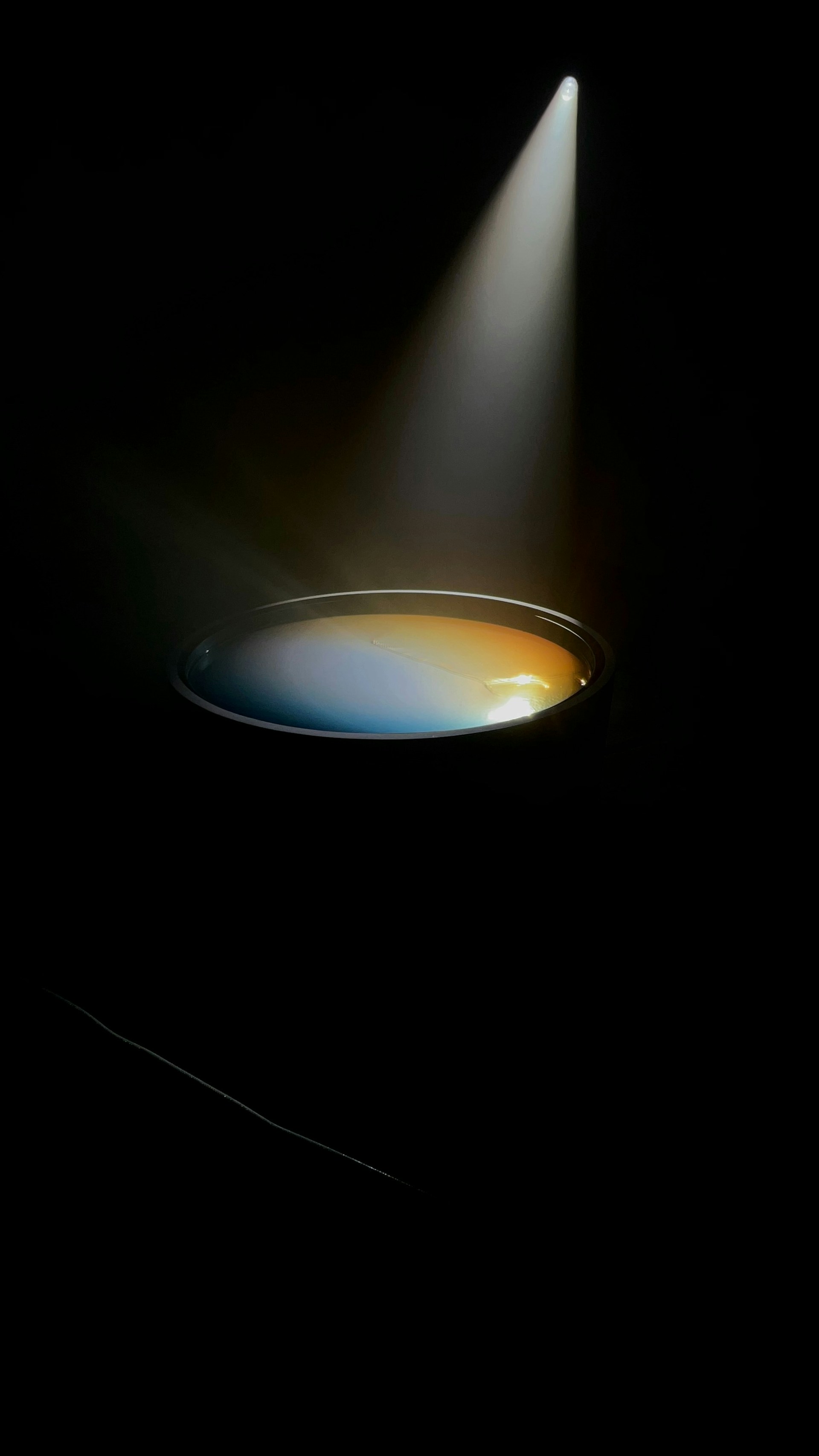 A light shines brightly on a black background
