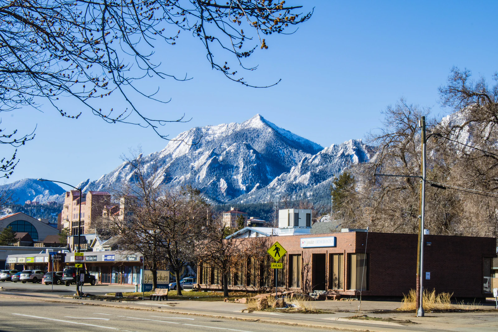 Street view toward the snow-covered foothills in Boulder, Colorado