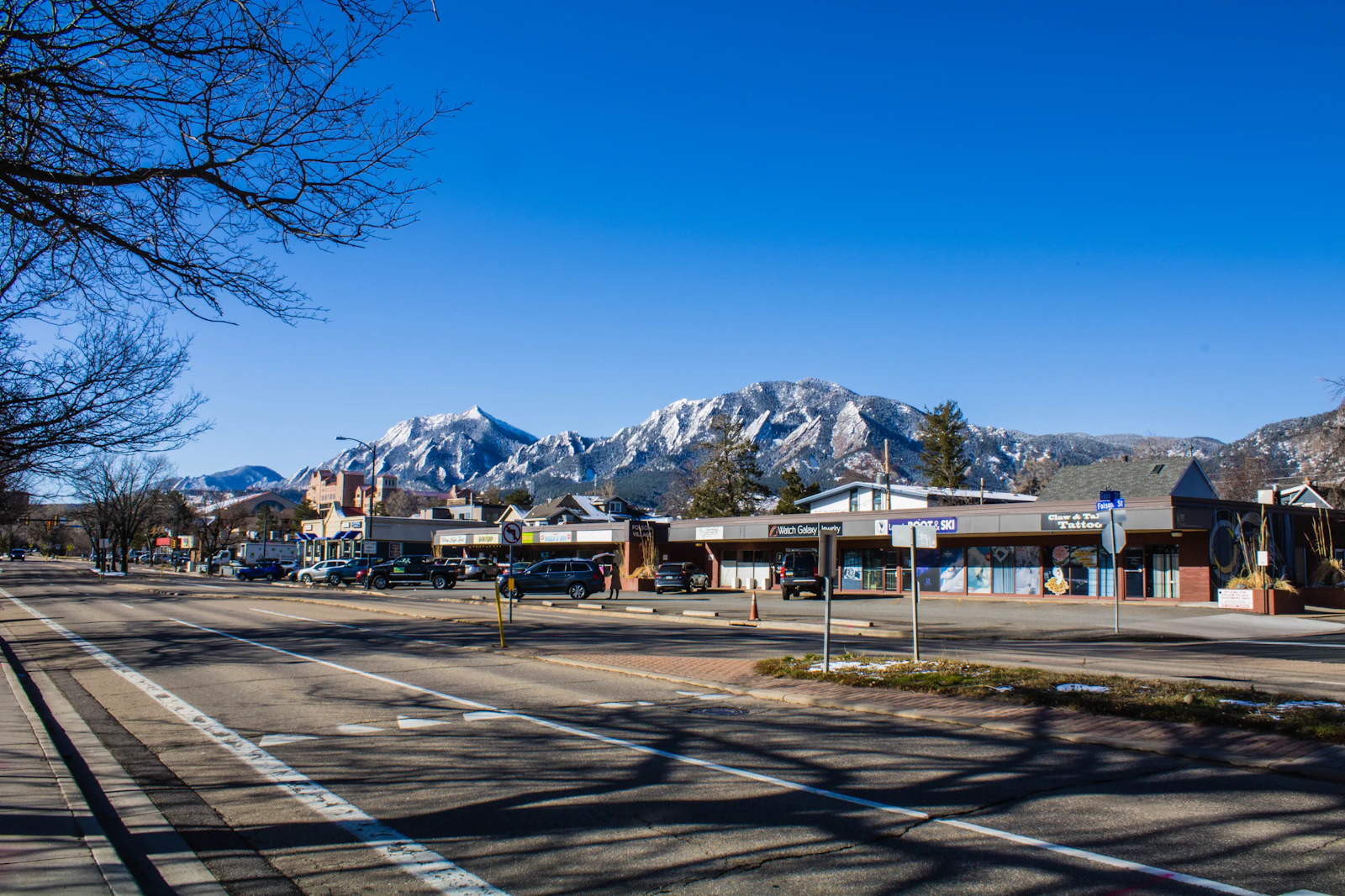 Residential street in Boulder, Colorado looking toward a snow-covered mountain