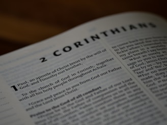 A close up of an open book with the words 2 corinham on it