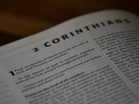 A close up of an open book with the words 2 corinham on it