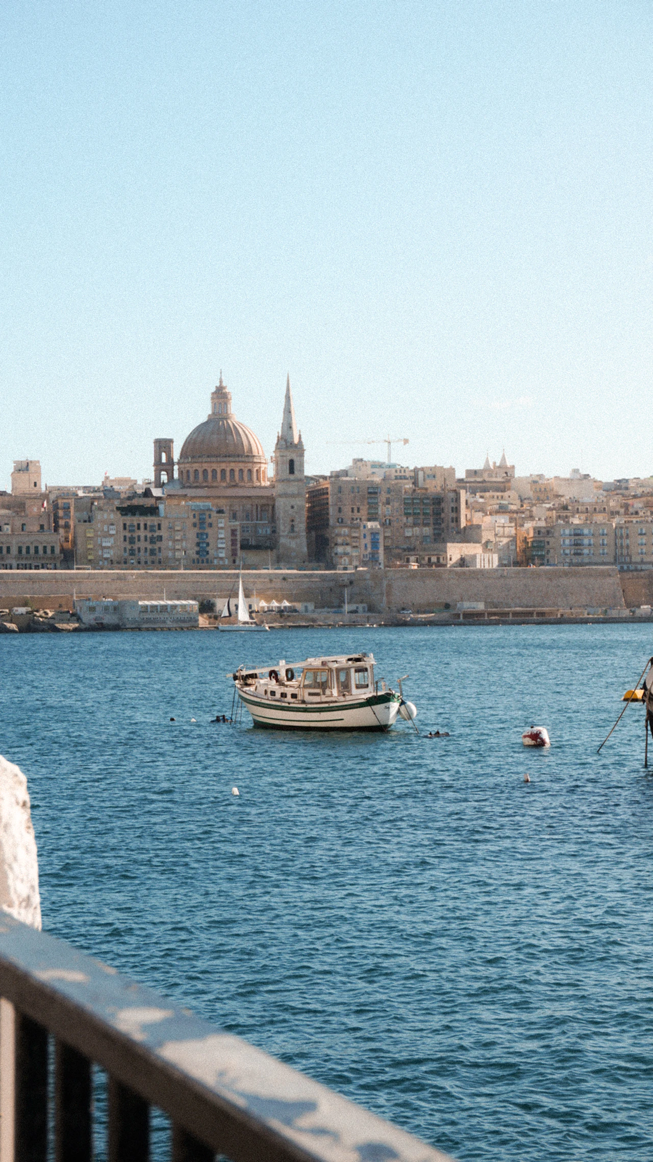 Boats moored in Valletta harbor, Malta, with the waterfront in the background