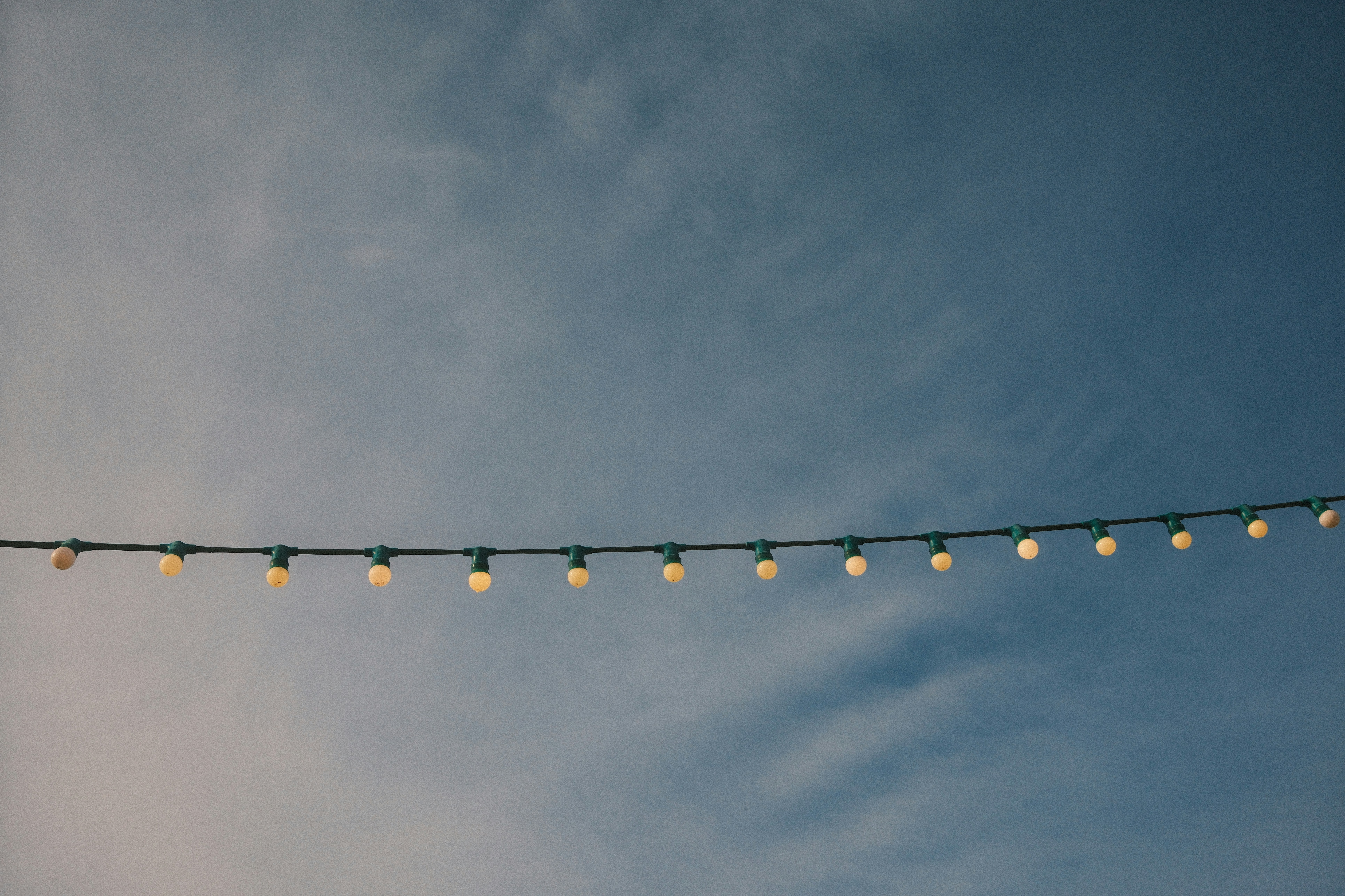 A string of lights is hanging in the sky