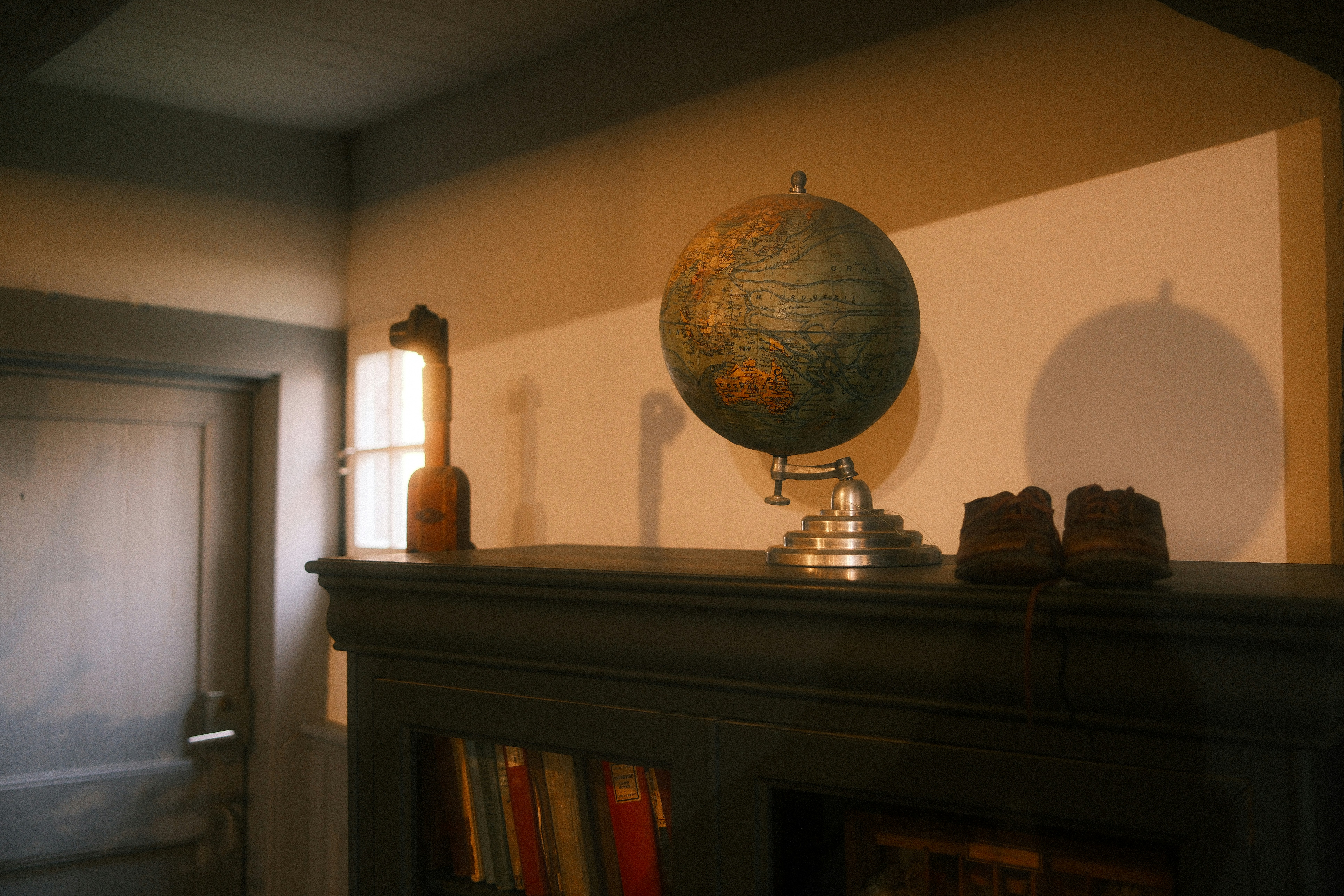 A globe sitting on top of a mantle in a living room