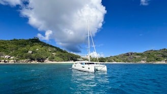 A white boat floating on top of a body of water