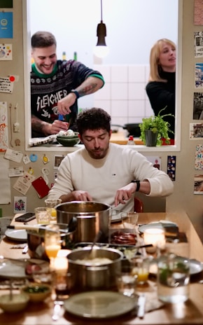 A group of people sitting around a table full of food