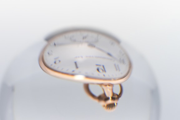 A close up of a clock inside of a glass ball