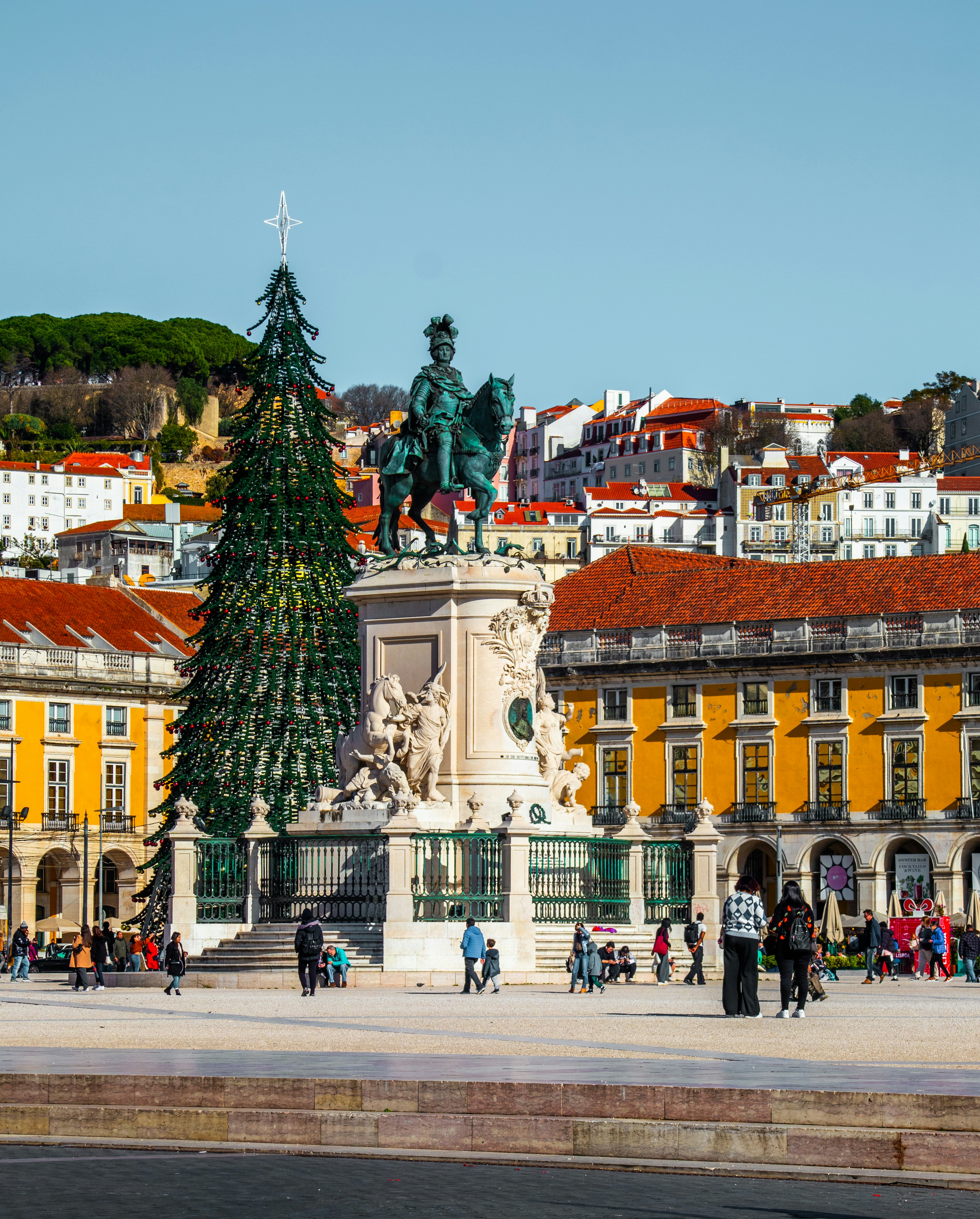 A large building with a christmas tree in front of it
