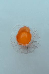An orange object sitting on top of a white surface