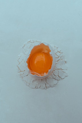 An orange object sitting on top of a white surface