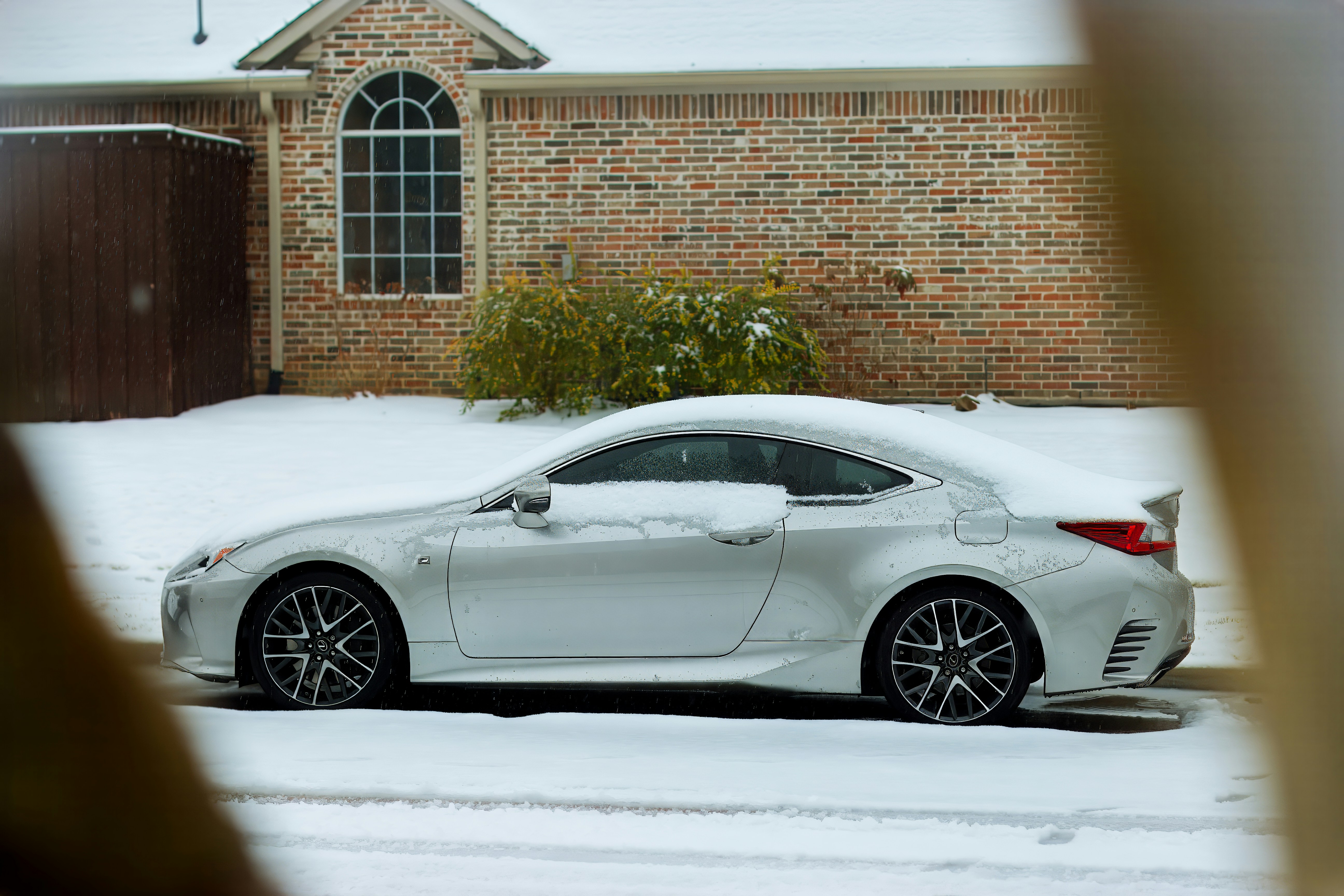 A white car parked in front of a brick building photo – Free Car Image ...