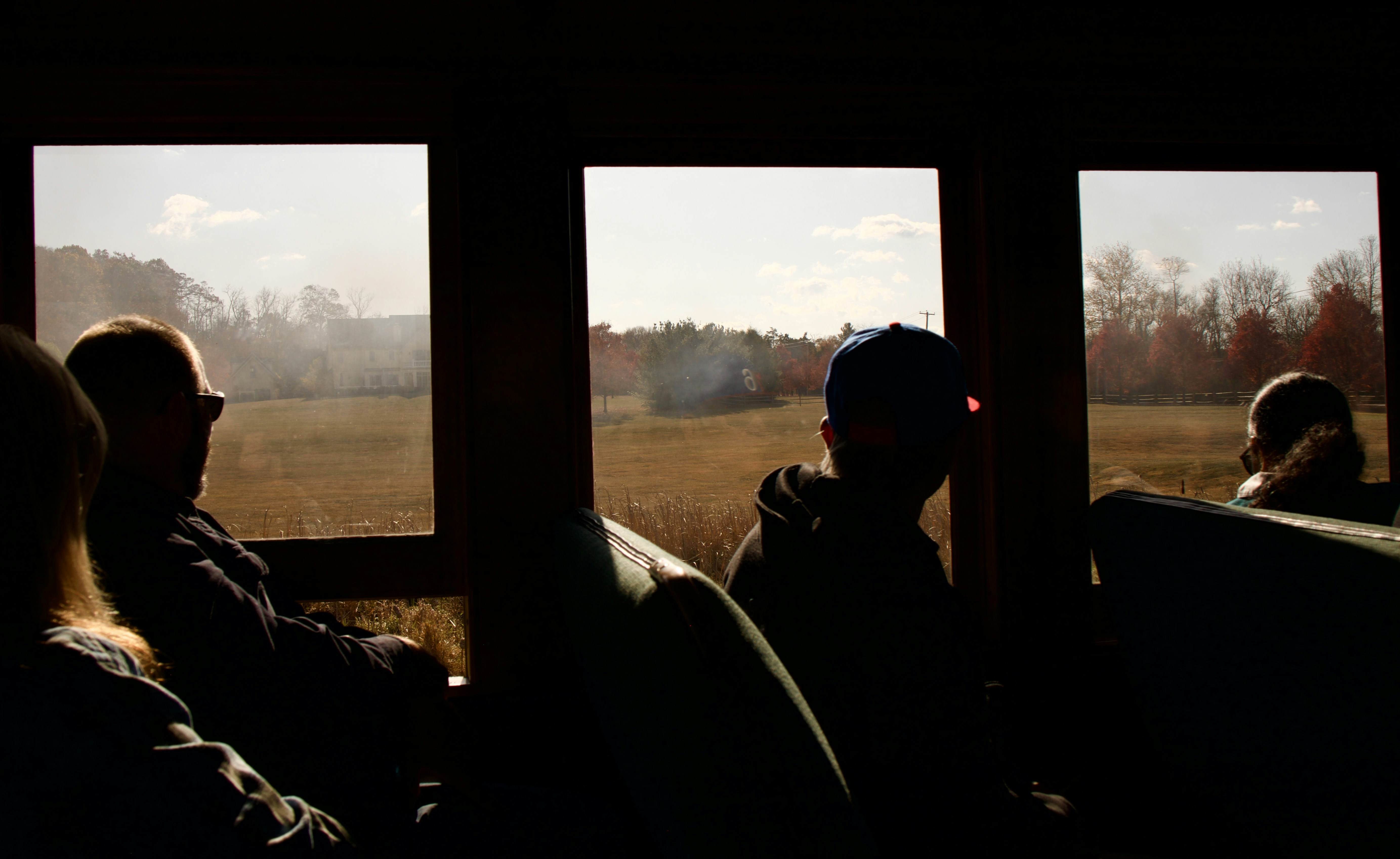 A group of people sitting next to each other on a train