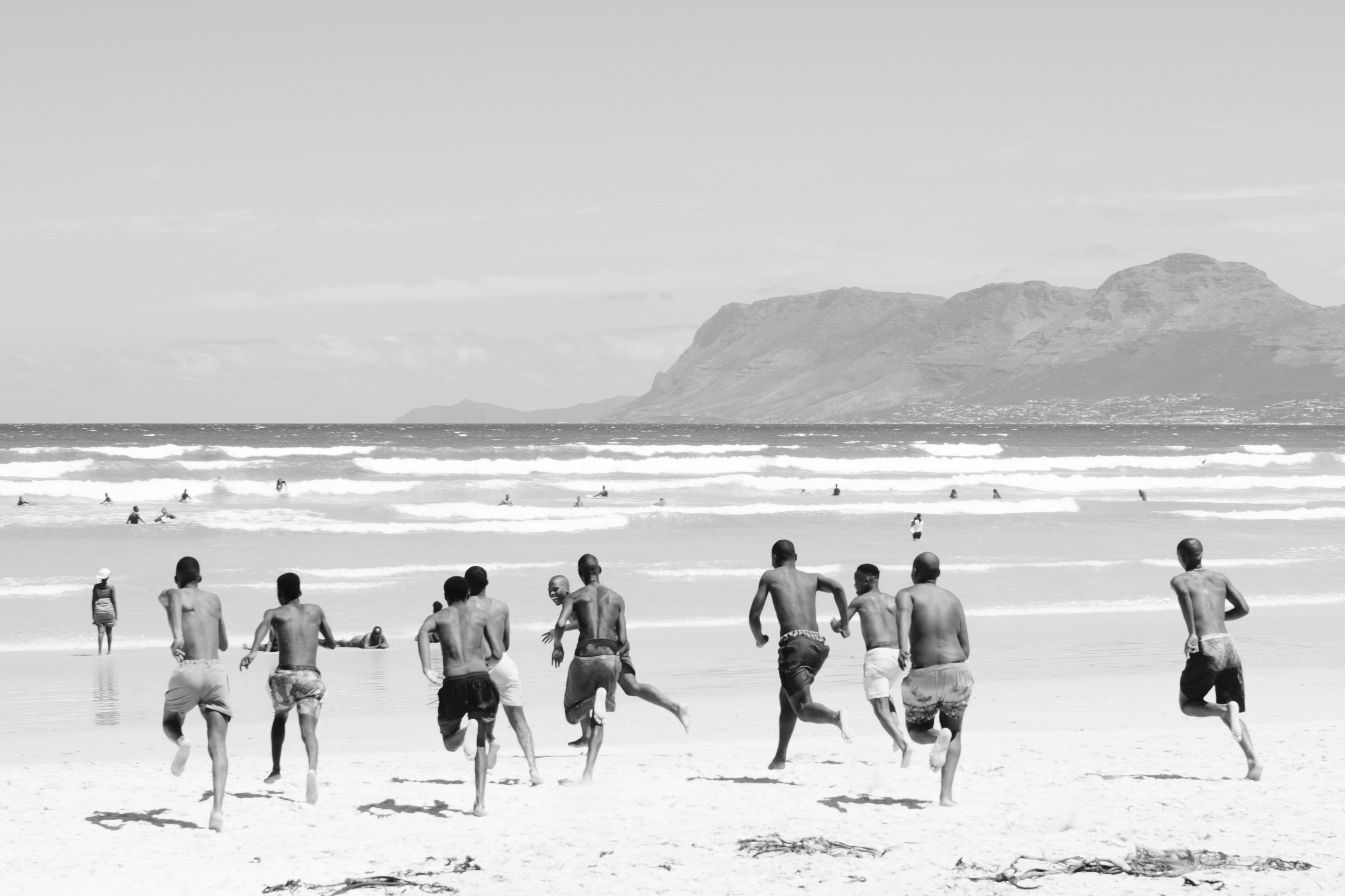 A group of people running on a beach
