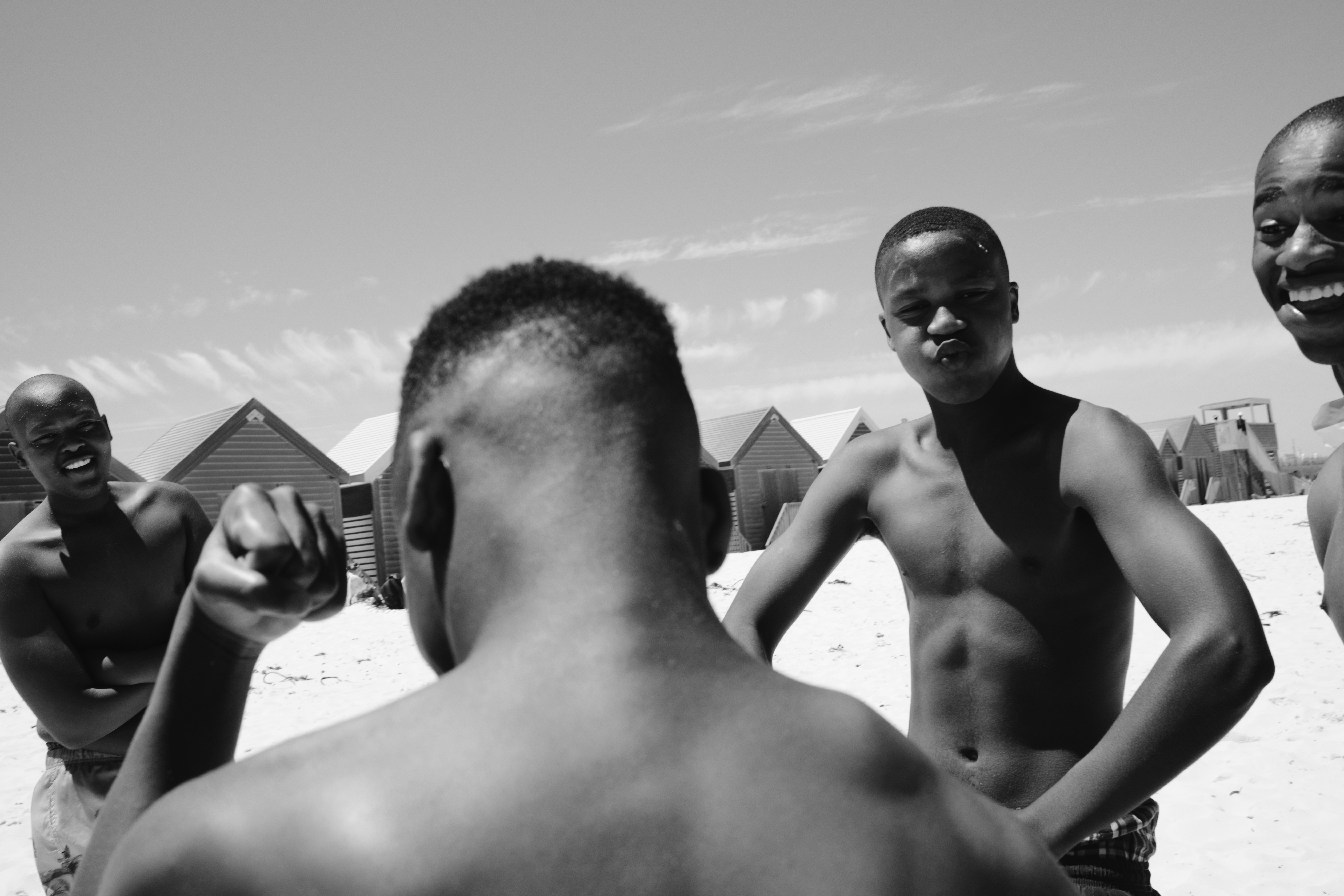 A group of men standing next to each other on a beach