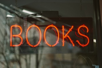 A sign that reads books in a window