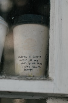 A cup of coffee sitting on top of a window sill