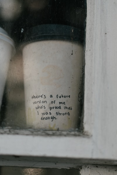 A cup of coffee sitting on top of a window sill
