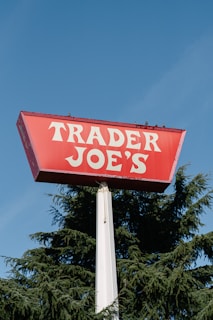 A red trader joe's sign on top of a pole