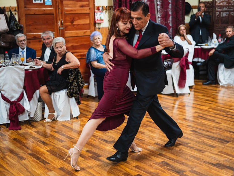 A couple of people that are dancing on a wooden floor