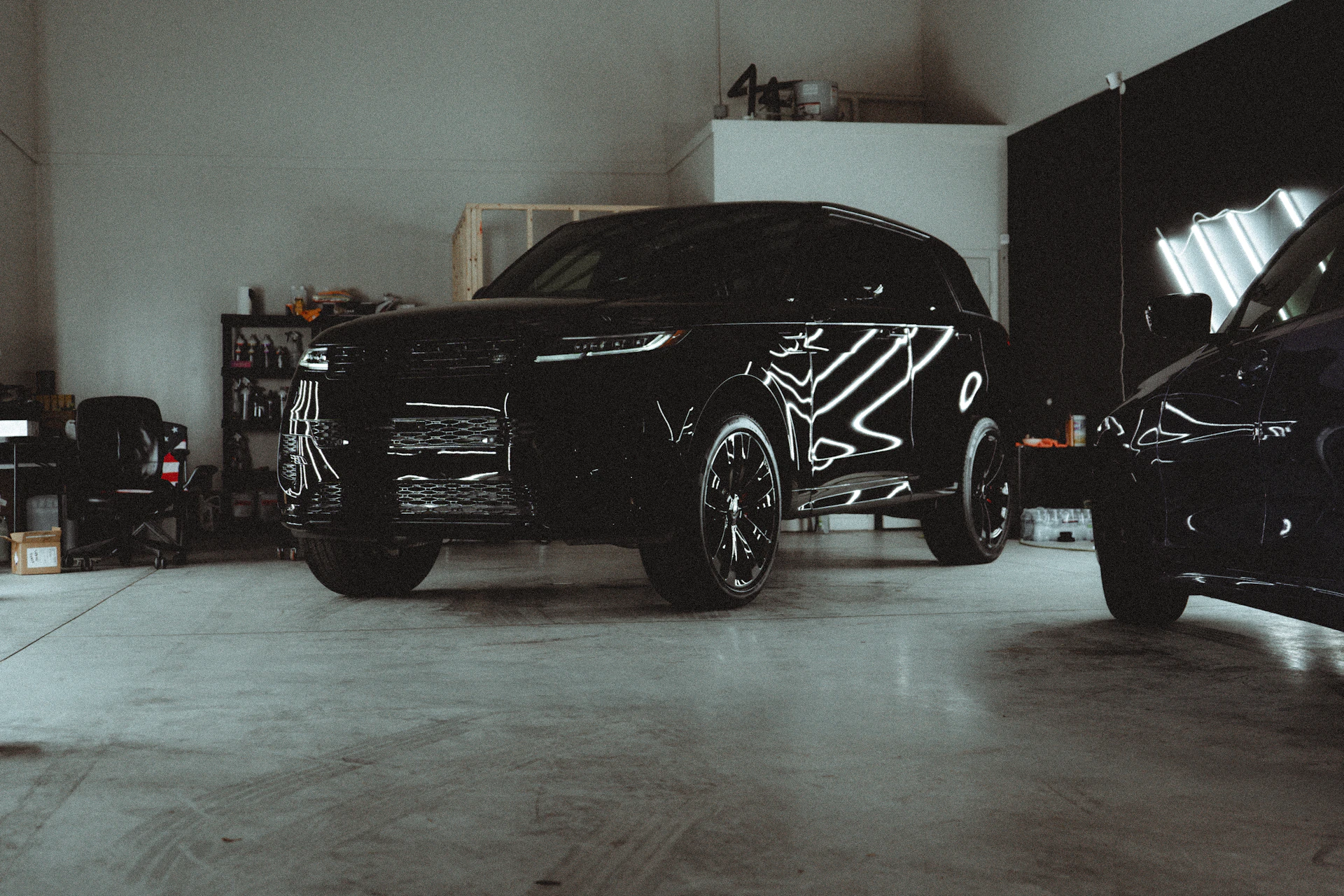 A couple of cars parked in a garage