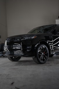 A black suv parked inside of a garage