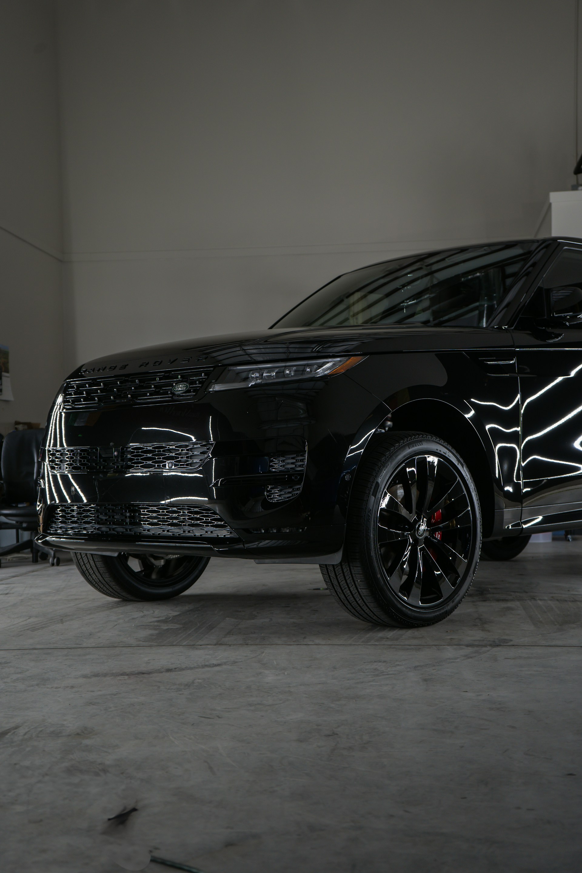 A black suv parked inside of a garage