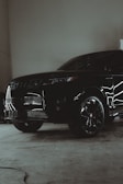 A black suv parked inside of a garage