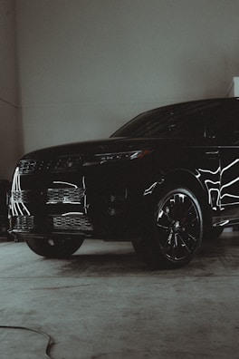 A black suv parked inside of a garage