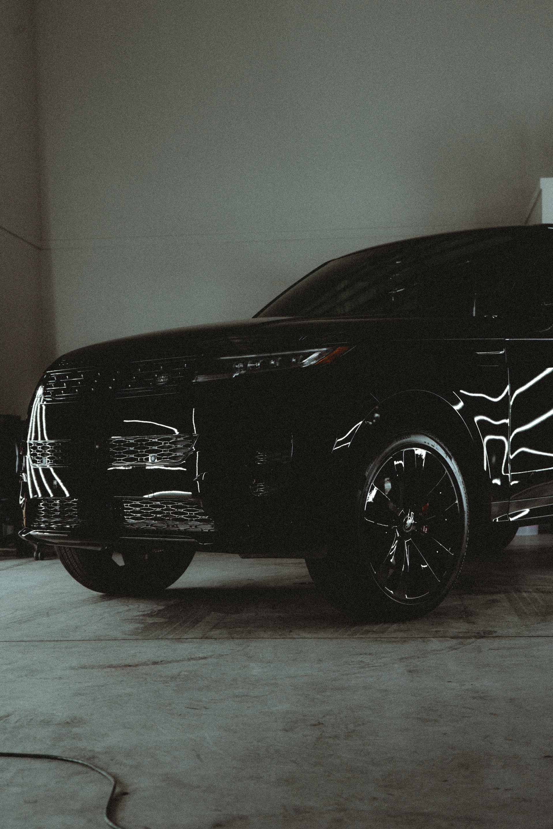 A black suv parked inside of a garage