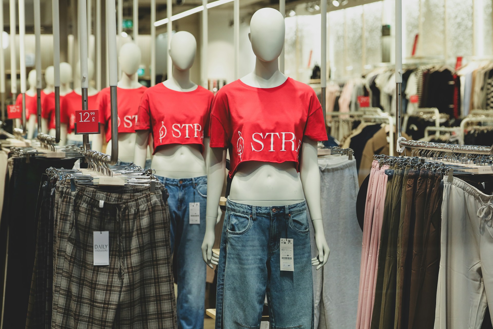 A couple of mannequins that are standing in a store