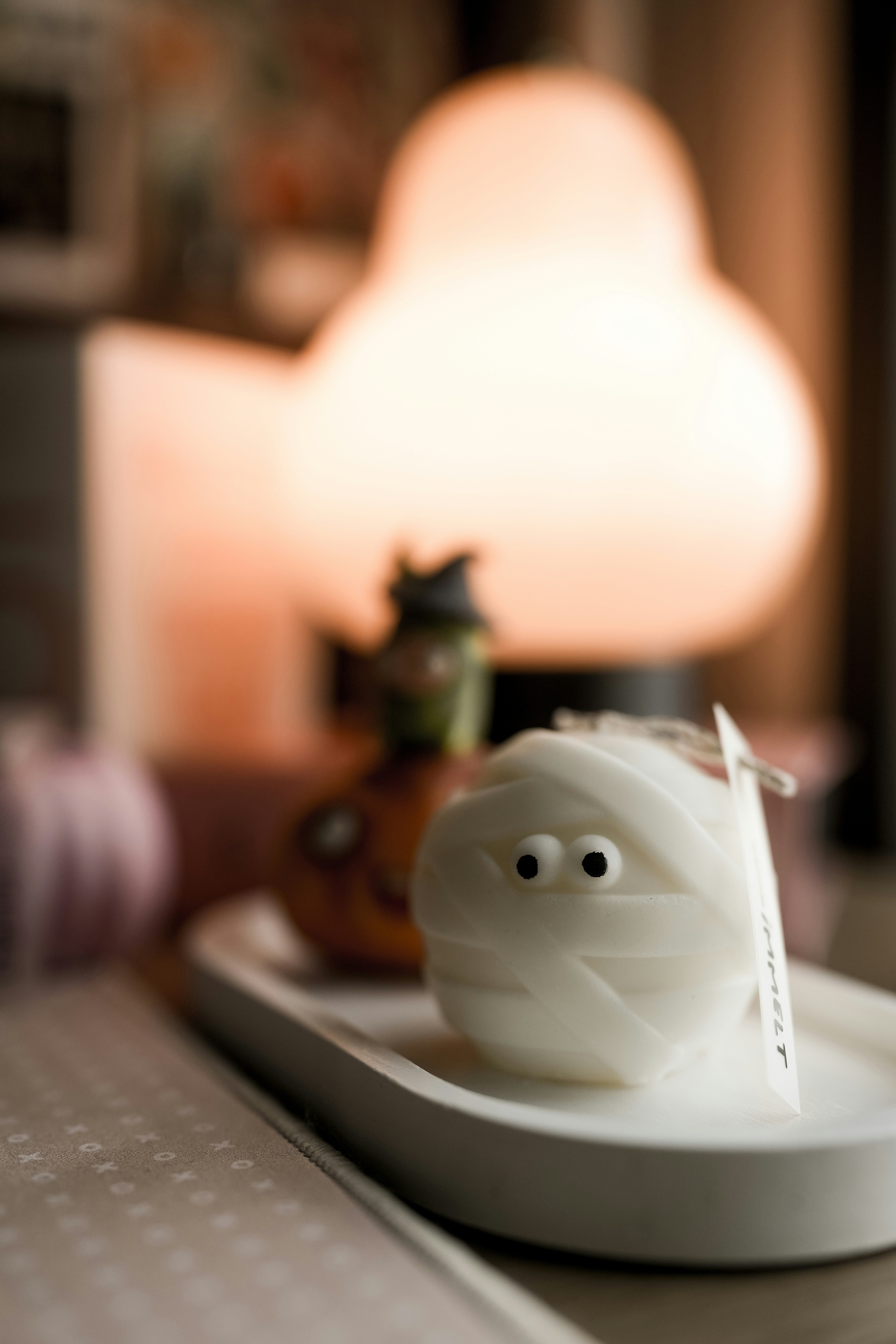 A white plate with a plastic ghost on it