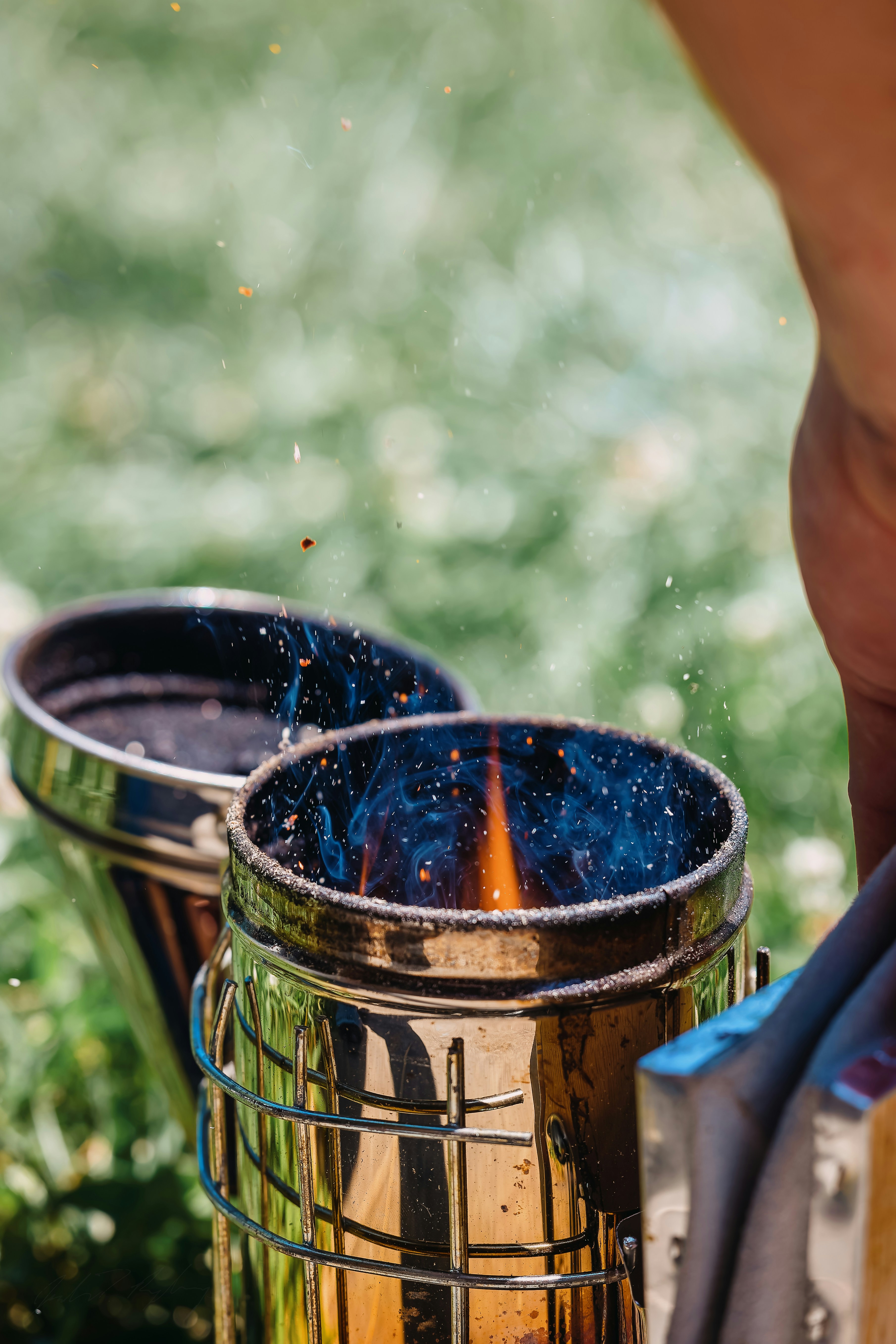 A person is putting something in a metal container