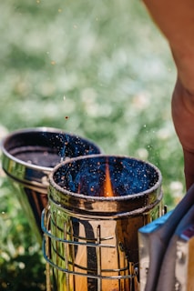 A person is putting something in a metal container