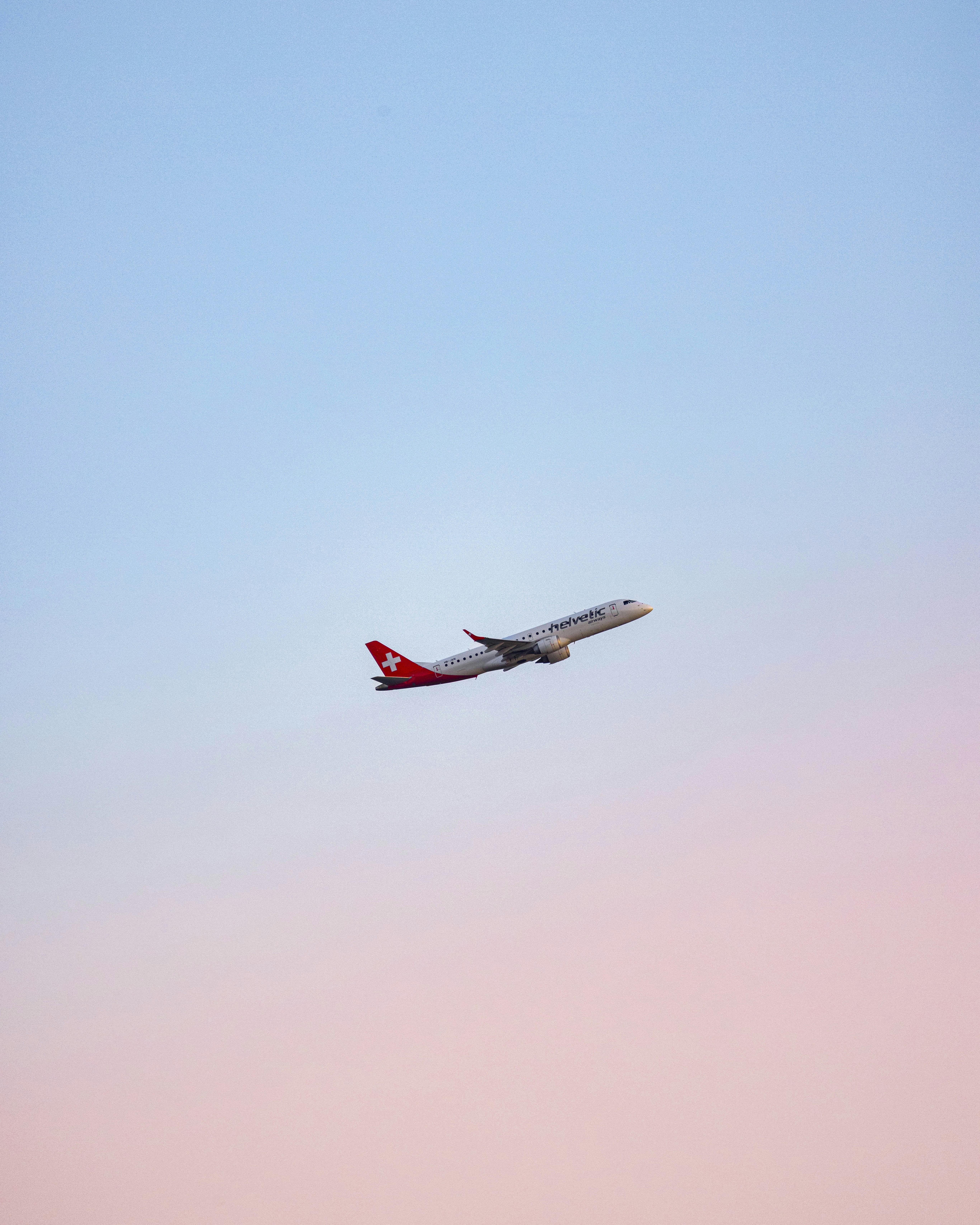 A large jetliner flying through a blue sky