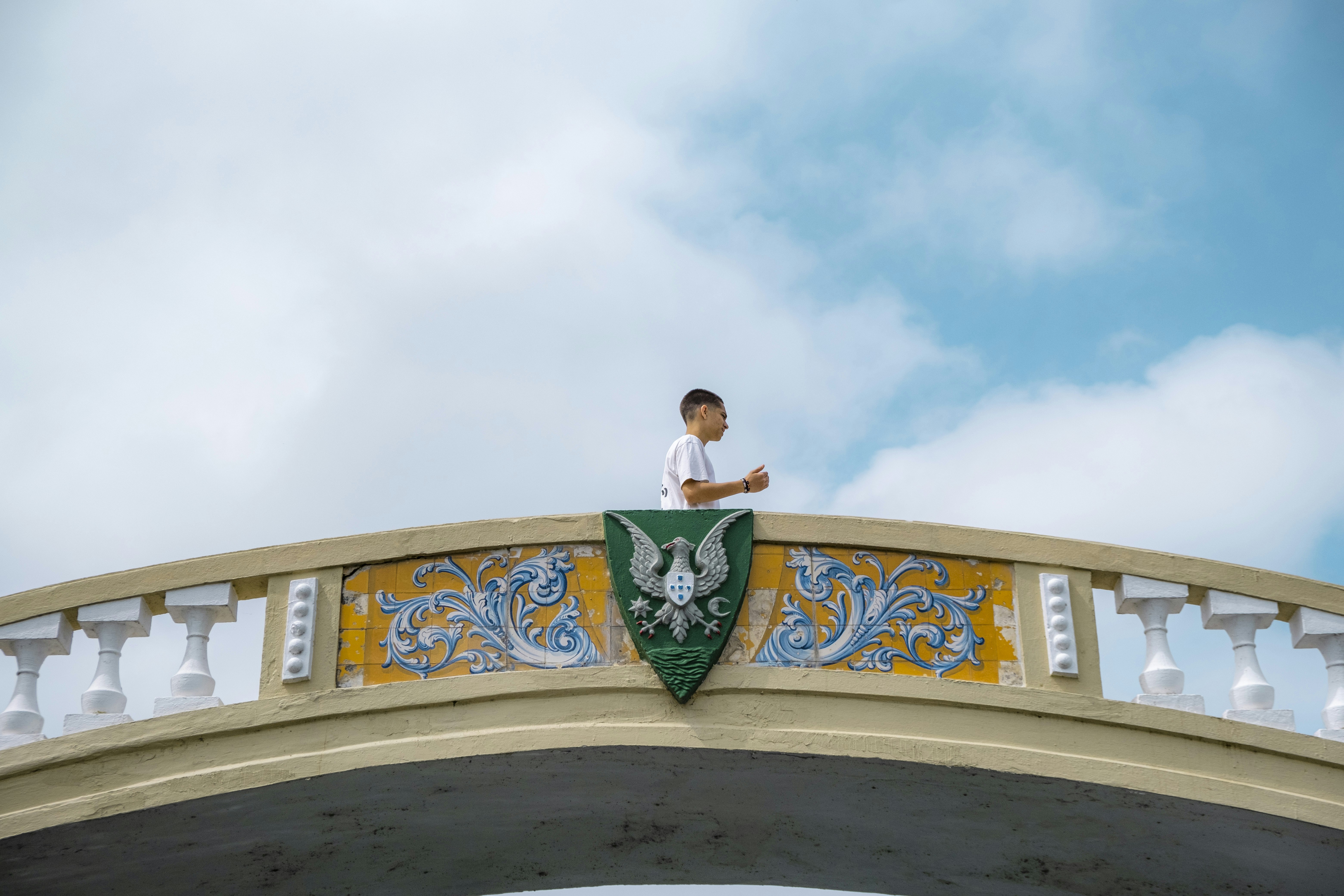 A man standing on top of a bridge