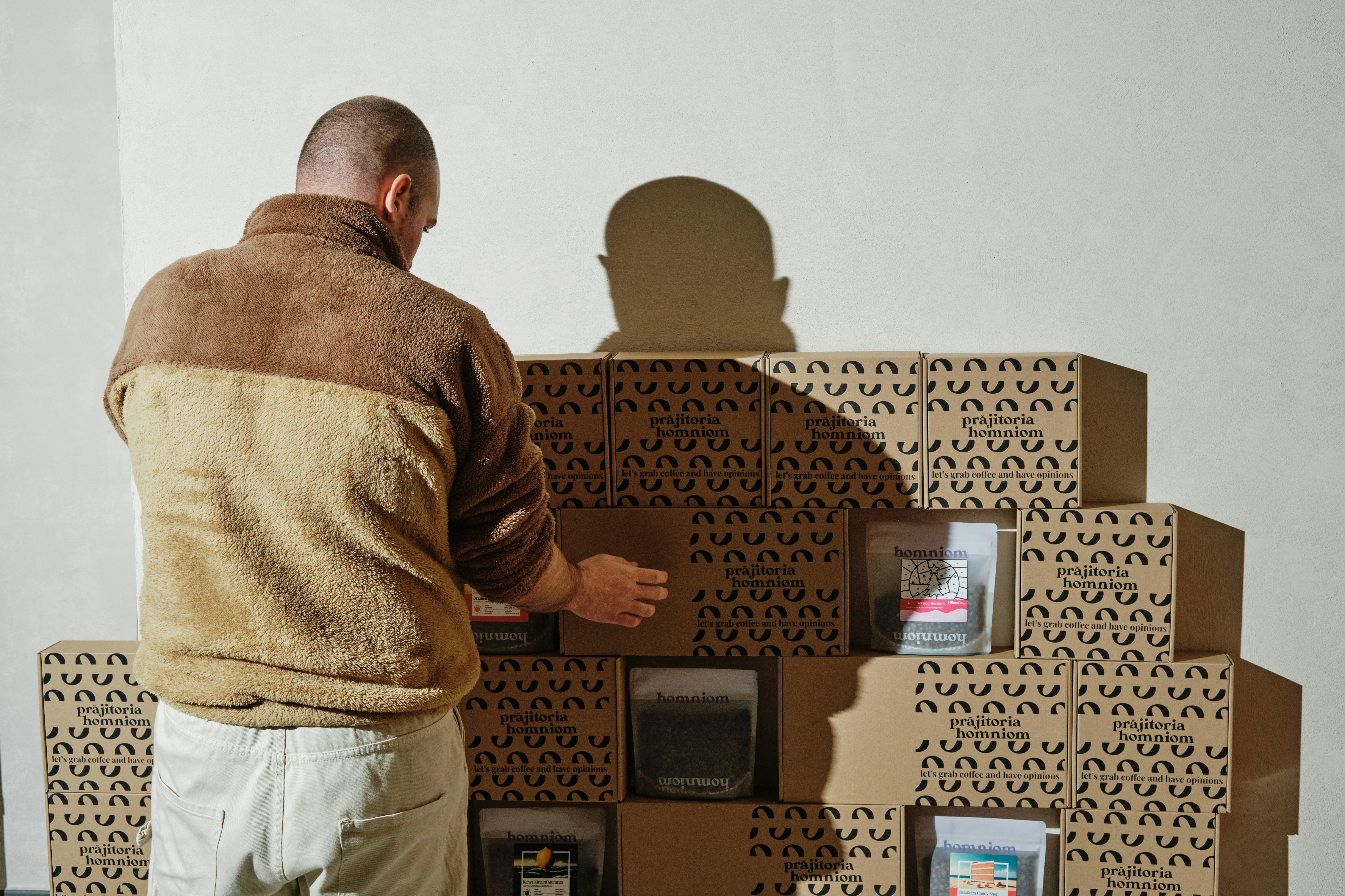 A man standing in front of a cardboard structure