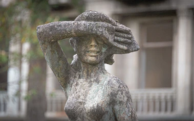 A statue of a woman with a hat on her head